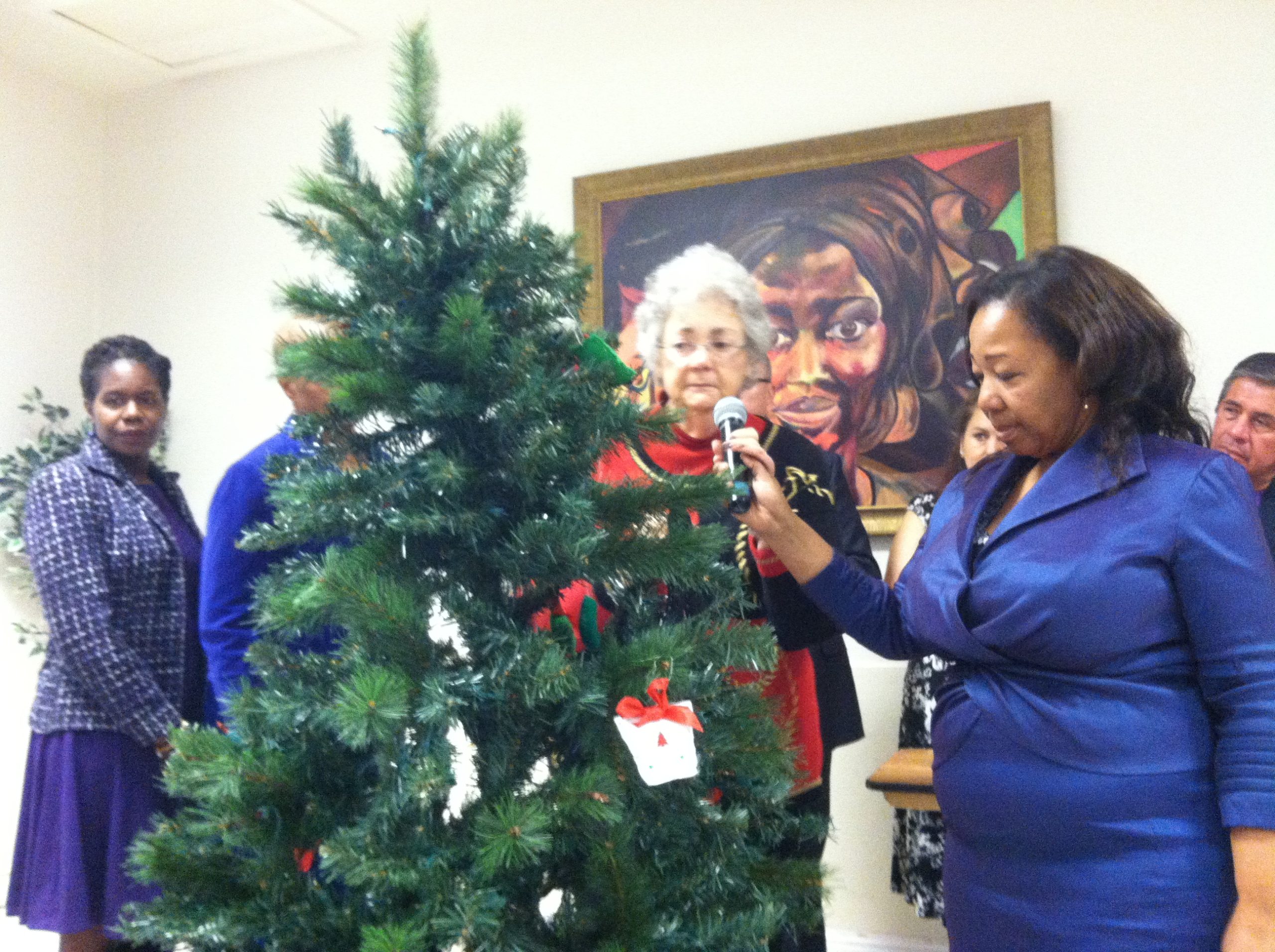 Lorrain Taylor holds the mic for a mother who lost a child to gun violence 21 years ago