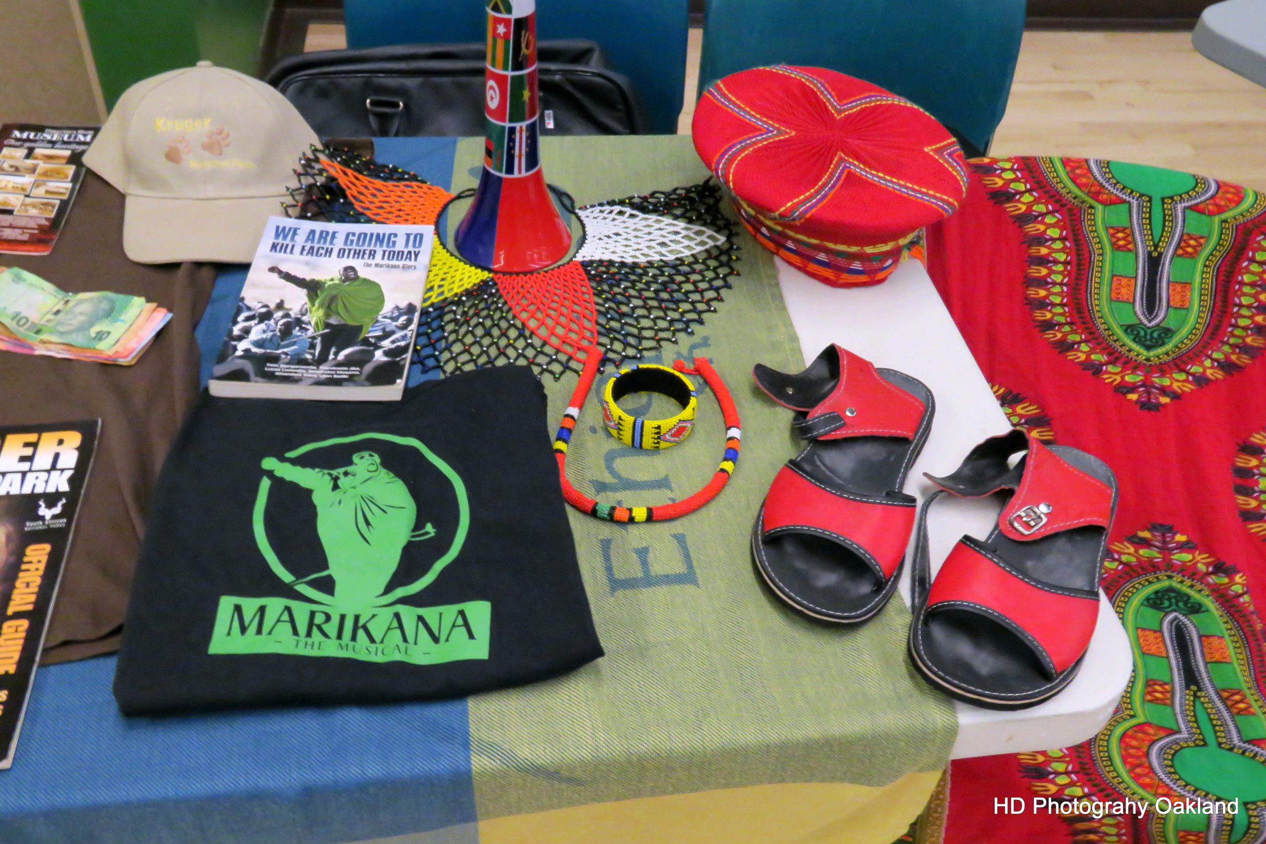 Souvenirs from the trip, including SA currency, Kruger Park guide, African clothing and instruments.