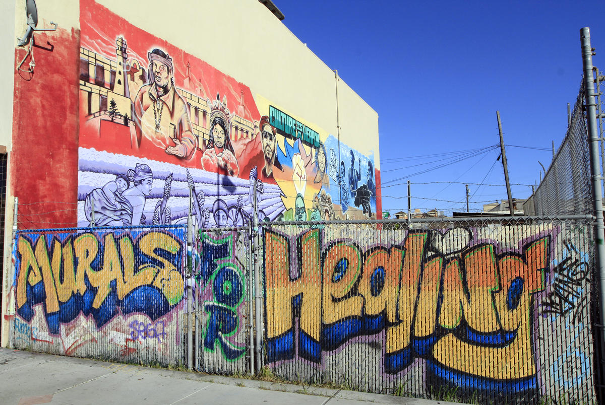 Cultural and political murals cover the walls of the Eastside Arts Alliance on International Boulevard on Wednesday, March 16, 2016 in Oakland, Calif. Students and professional artists team up to create the murals.(Laura A. Oda/Bay Area News Group)