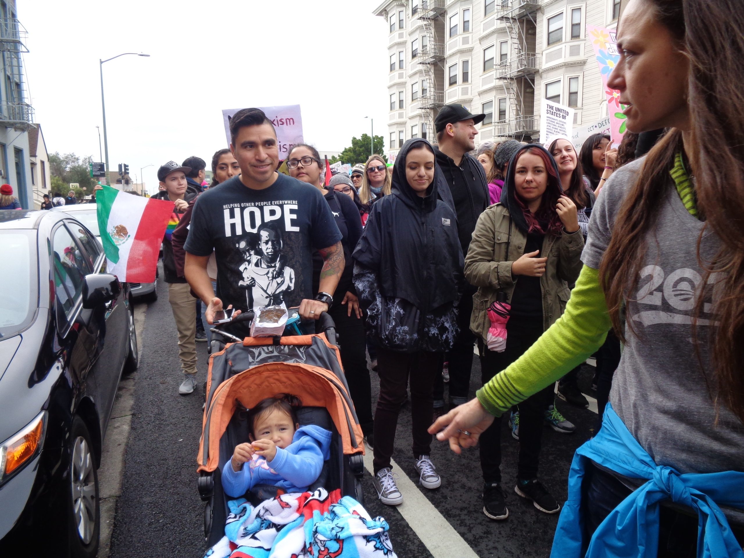Man with baby and signs