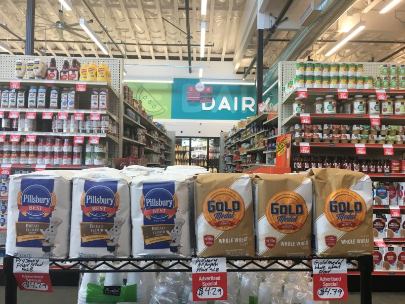 A closeup image of a row of flour inside a grocery store.