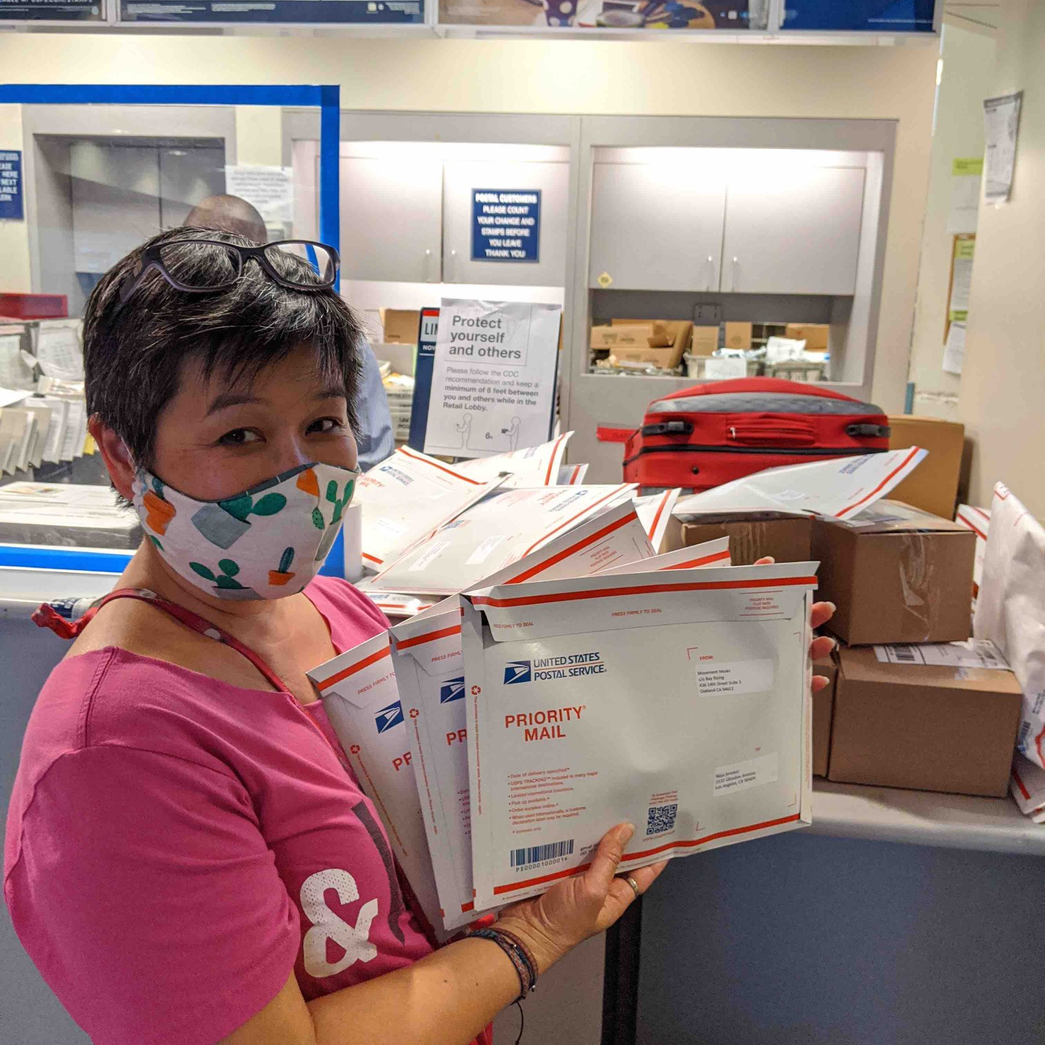 Photo: Kimi Lee dropping off packages for shipping at the USPS