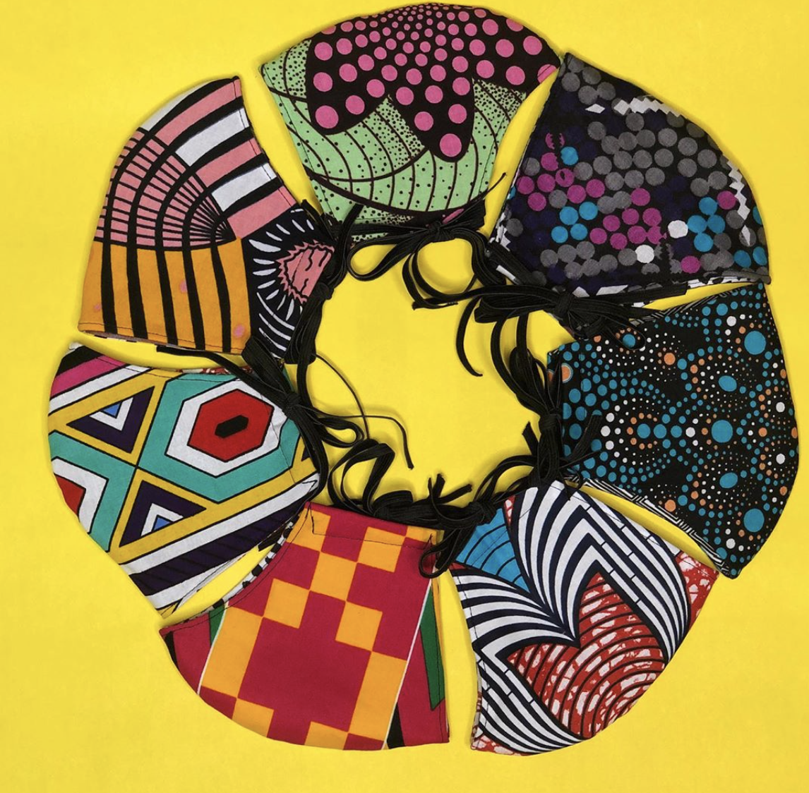 a yellow background with a ring a colorful, printed fabric masks.