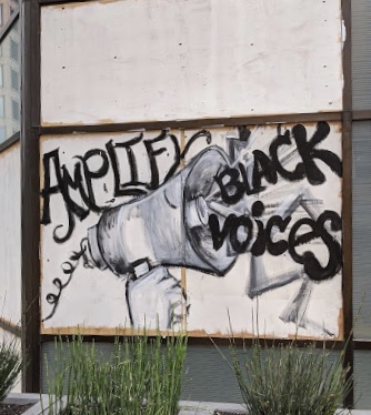 An image of a megaphone with the words "Amplify Black voices" coming out of it.