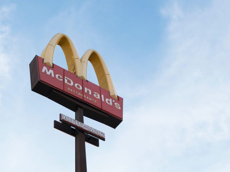 The McDonald's sign against the blue sky.
