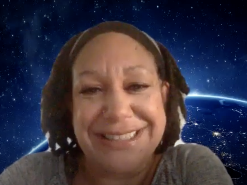 An African American woman is on a Zoom webinar with earth and outer space as the background.