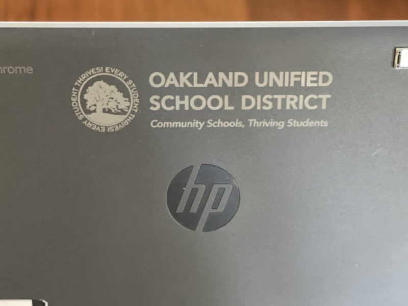 An image of a grey Chromebook laptop with OUSD engraved on it.