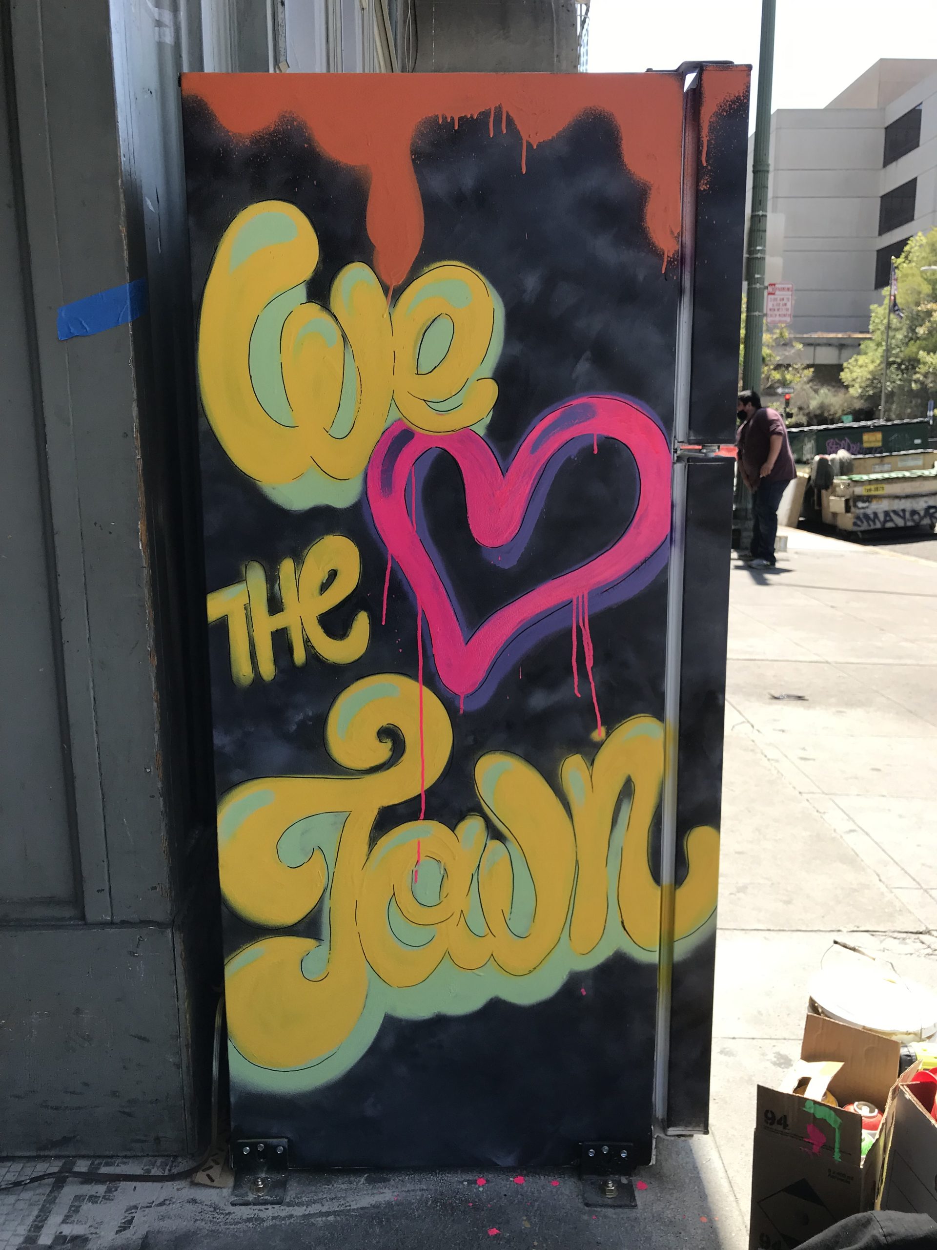 A side of a community fridge that says "We Love The Town"