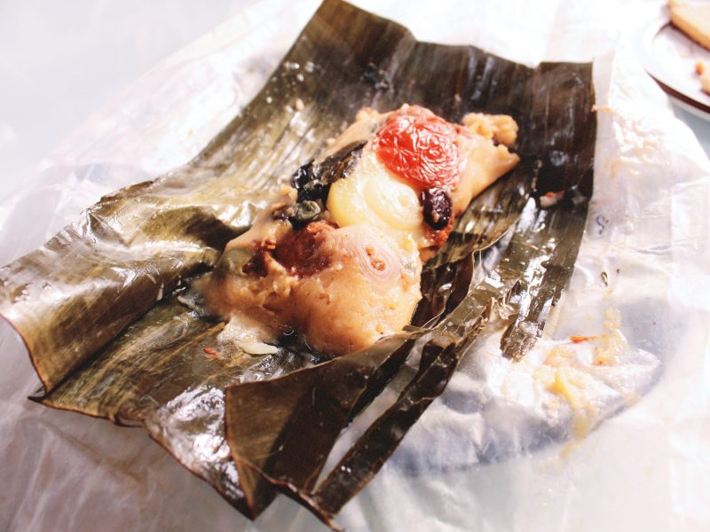 A leaf is open. What is inside? It looks like many ingredients that go inside a Nicaraguan tamale!
