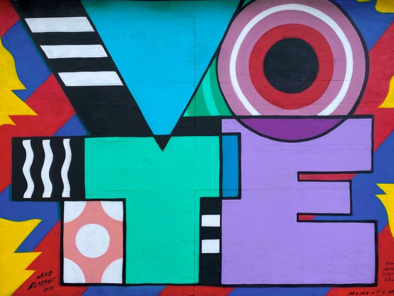 A bright mural that says "Vote"