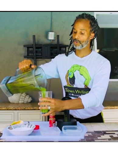 An image of an African American man pouring water and working with plants.