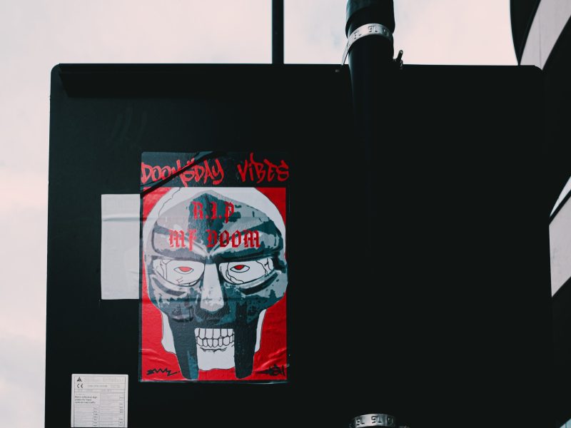 a poster of MF Doom in a mask with the words doomsday vibes.