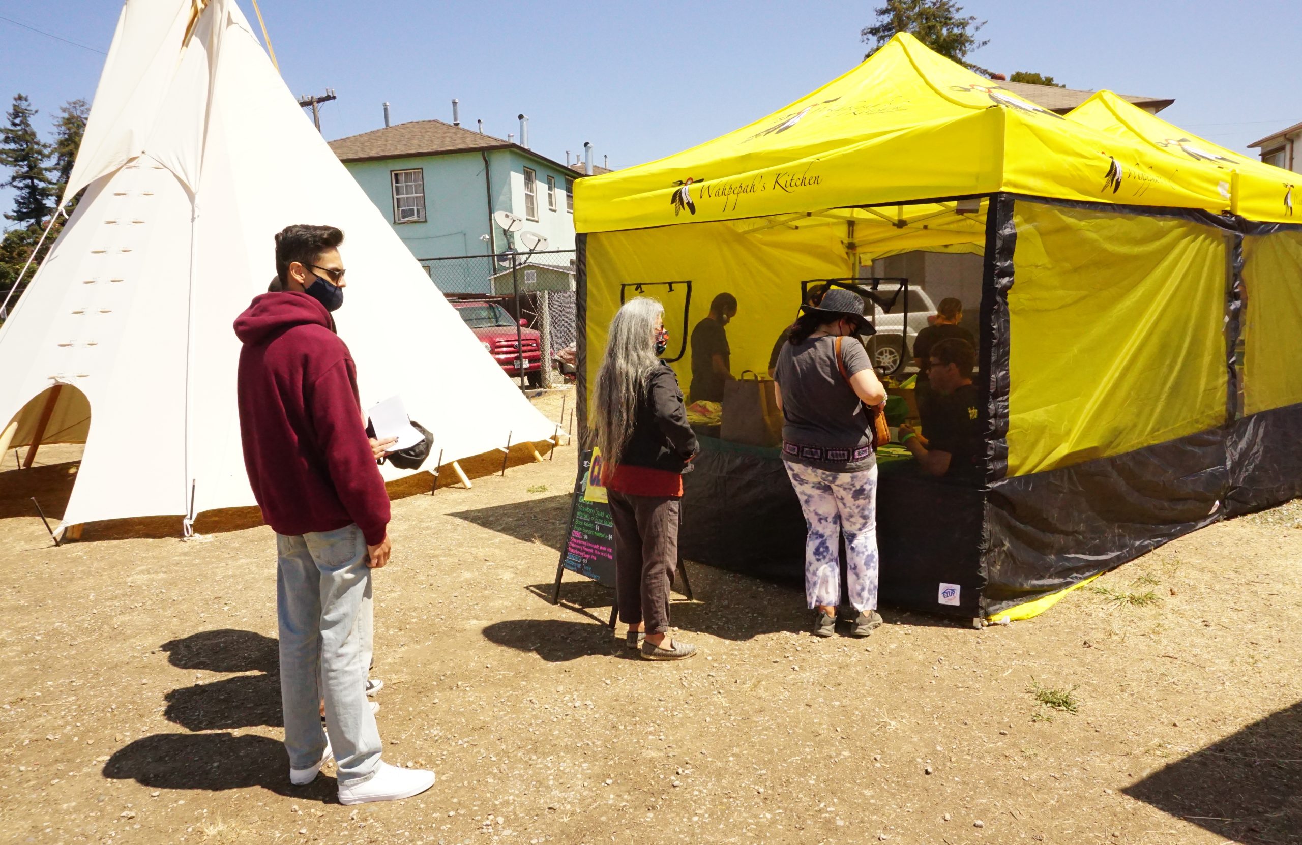 a yellow tent selling Native dishes at the Indigenous Red Market.