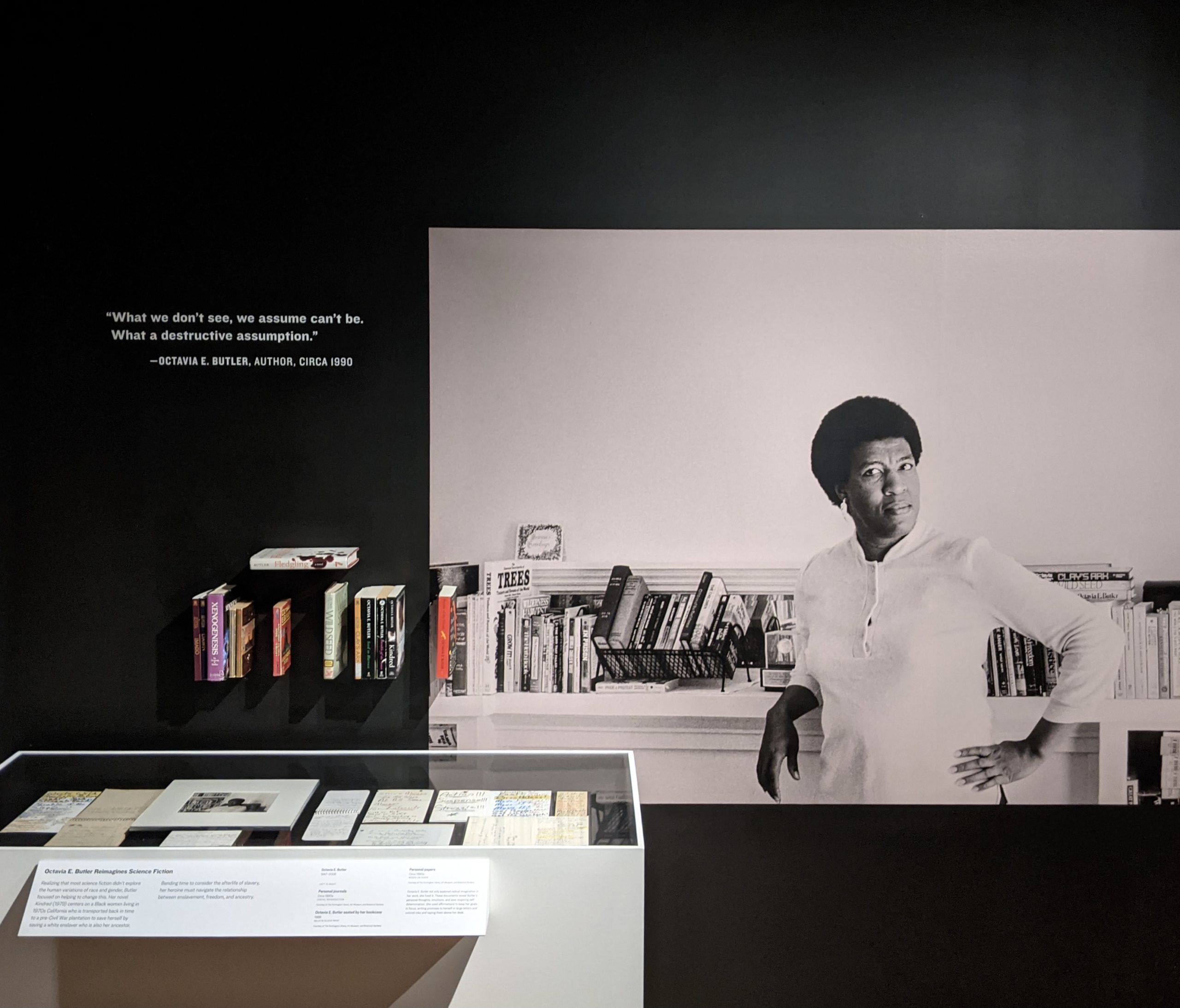 a museum exhibit with a large photo of an African American woman with short hair, writer Octavia Butler.