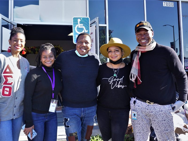 Five African Americans stand and smile for camera.