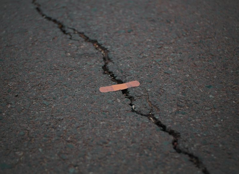 a bandaid covers a cracked ground