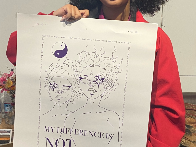 an image of an African American girl smiling while holding a poster drawing that she created