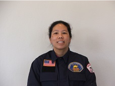An Asian American woman stands for portrait
