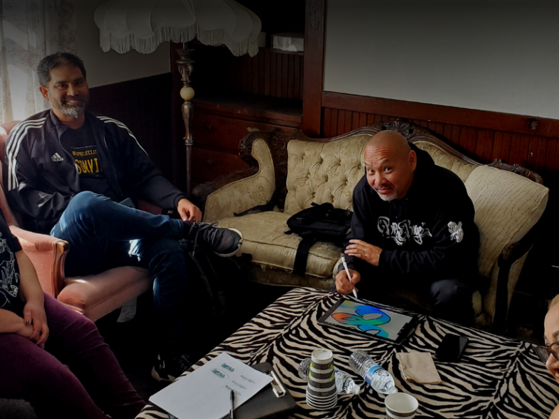 Photo: Oakland Voices alumni meet with Norman Vogue Chuck and his wife Gloria.