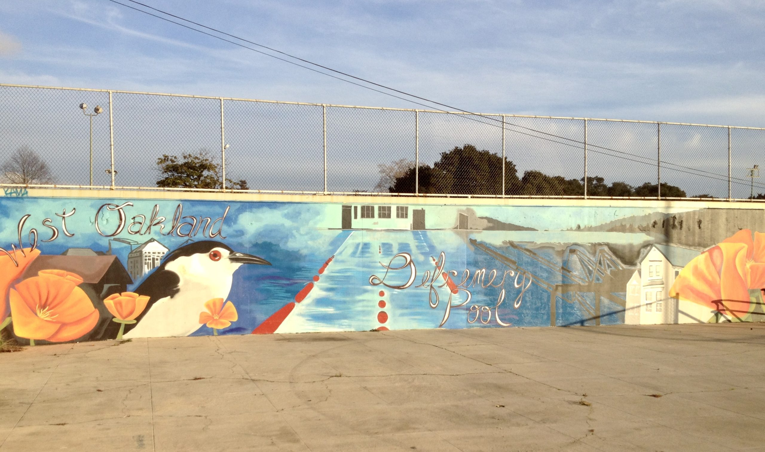 A colorful mural that says West Oakland and DeFremery Pool