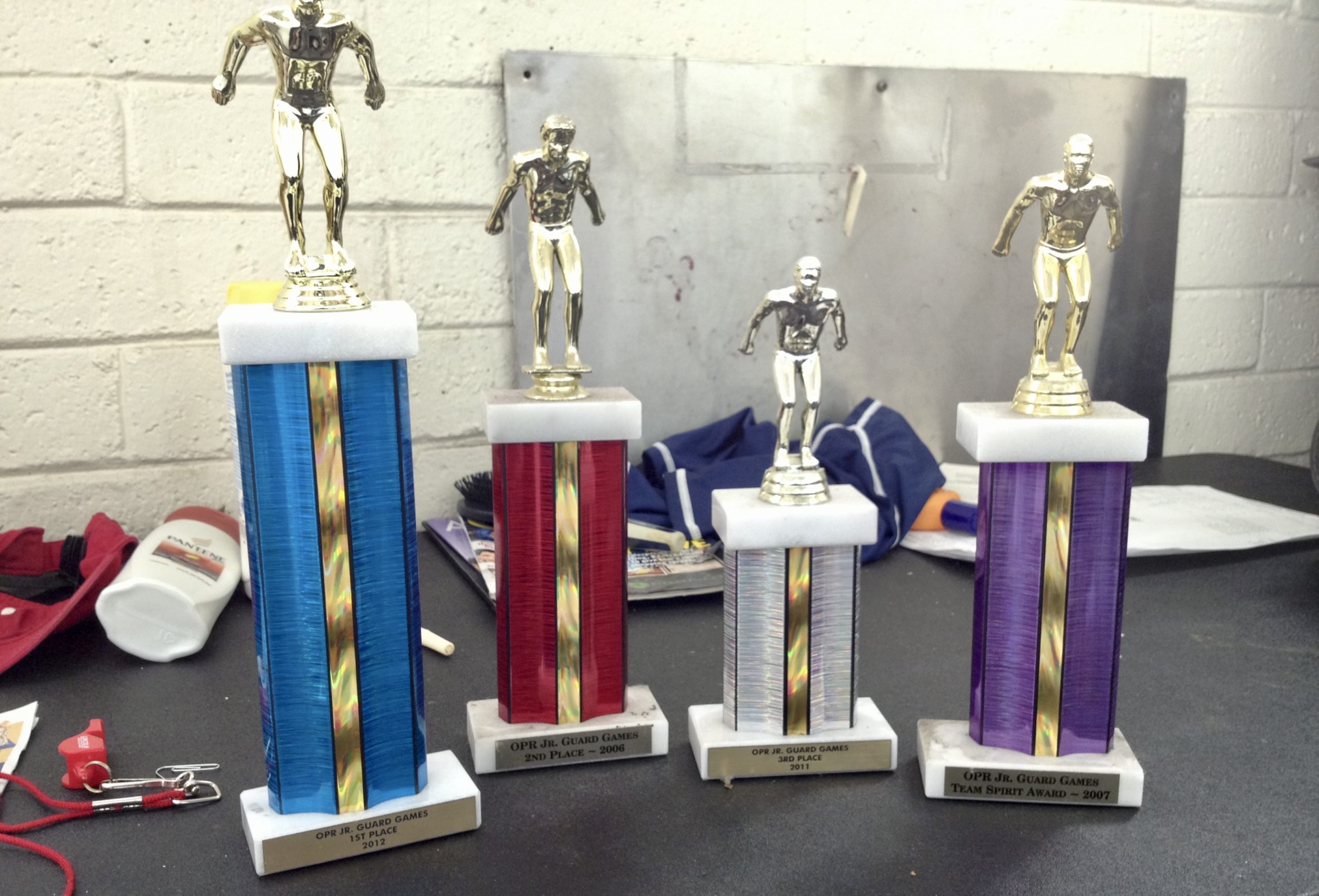four colorful statues of swimmers at the top, trophies at a swim rec center