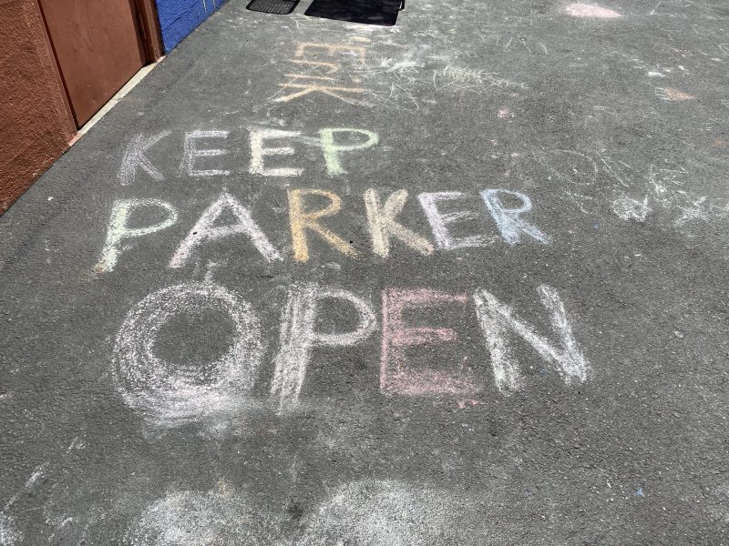 Chalk art that says "Keep Parker Open"