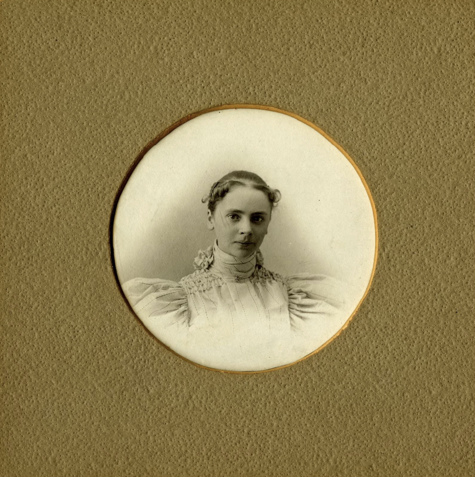 a sepia image of a young woman with Victorian dress