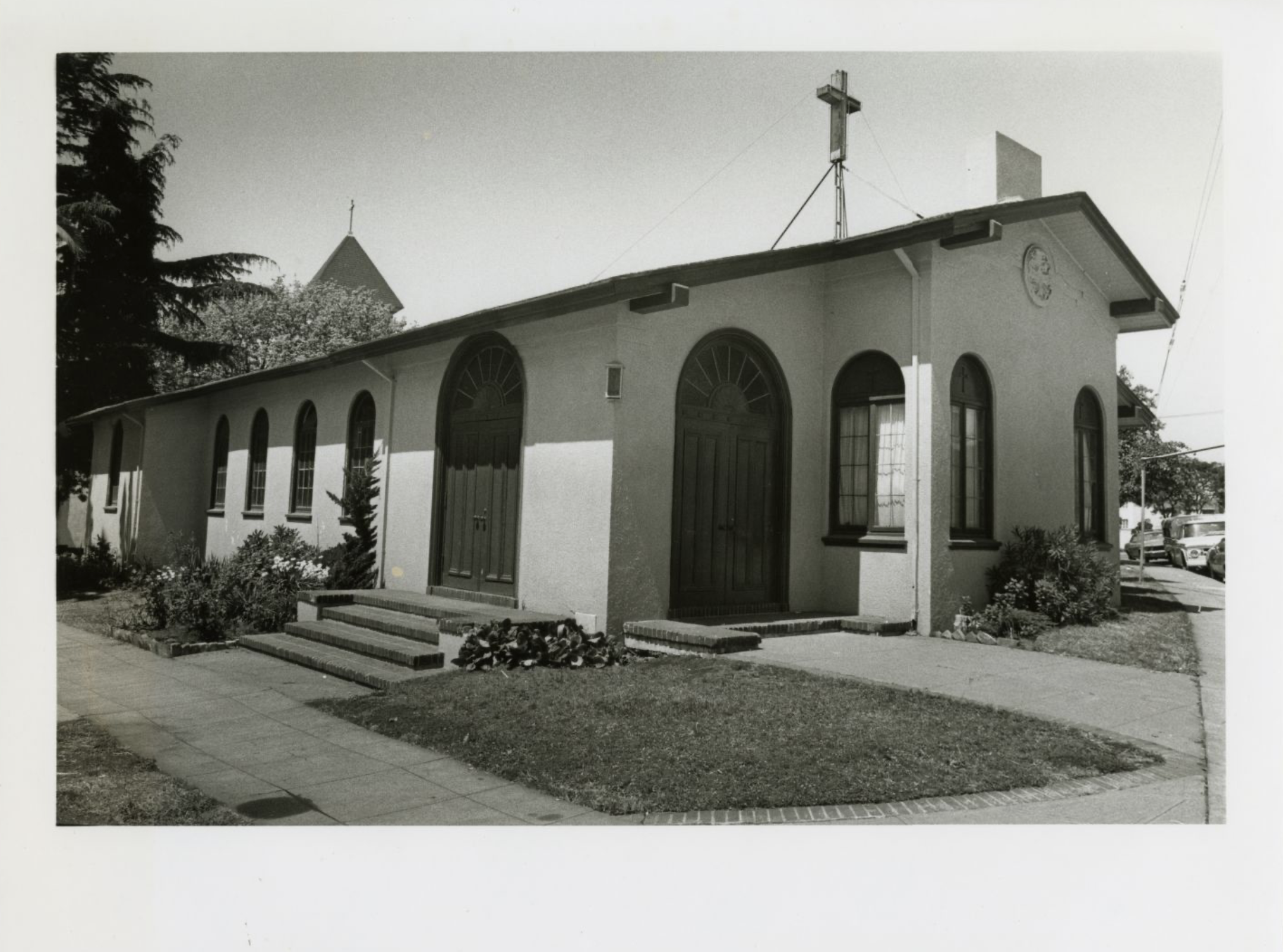 black and white photo of outside of small church