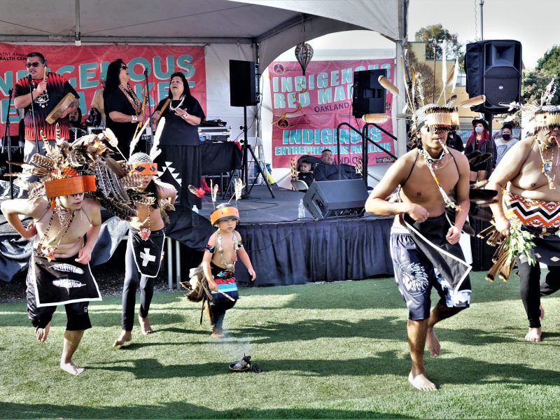 Image of Pomo Native American dancers at an outdoor event.