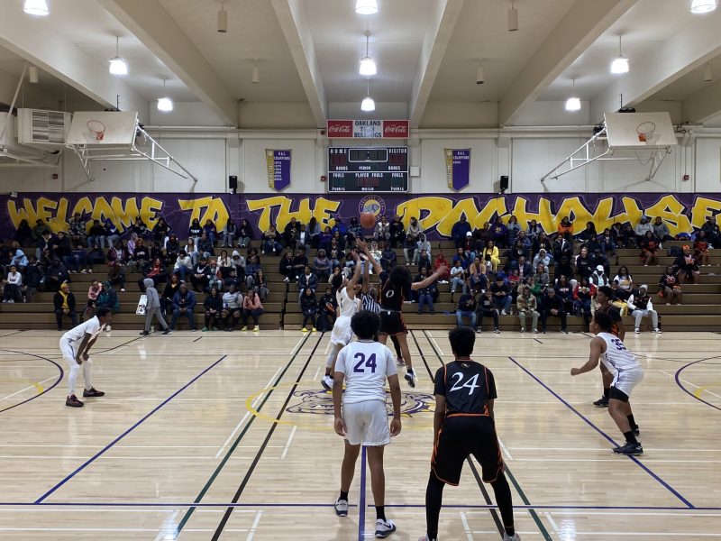 A group of boy basketball players in a heated game