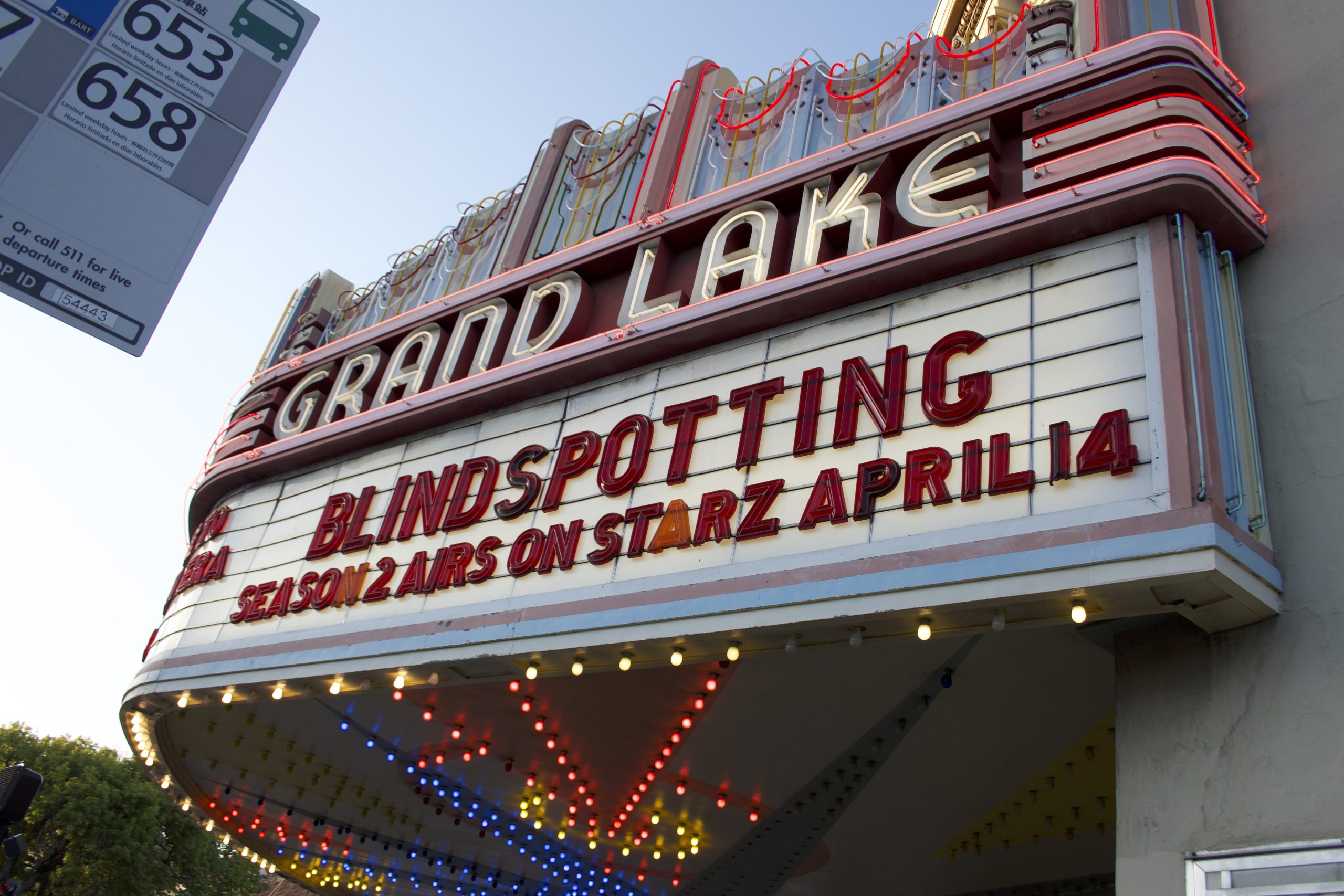 A marquee says "Blindspitting" STARZ April 14 at the Grand Lake movie theater