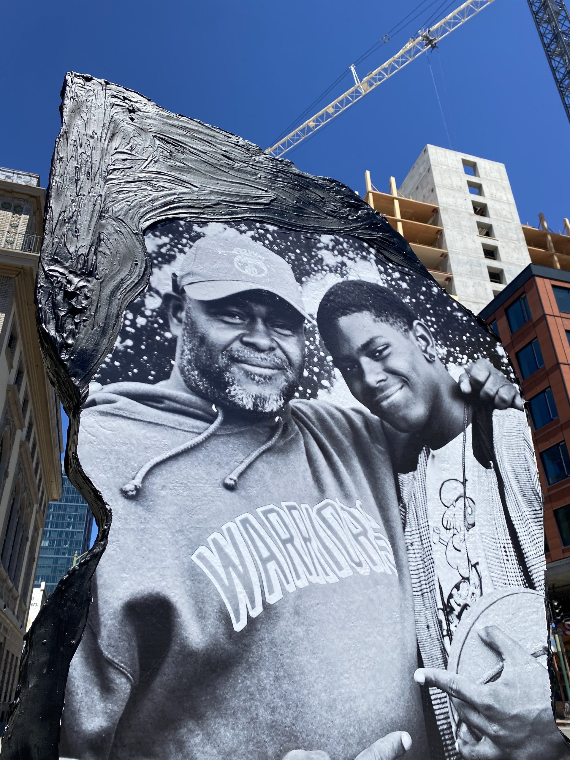 a large black and white photo displayed on a piece of styrofoam concrete in the sun