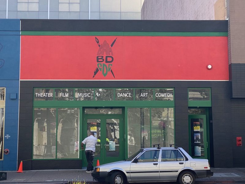 a window front with black, red, and green and words BAMBDCDC