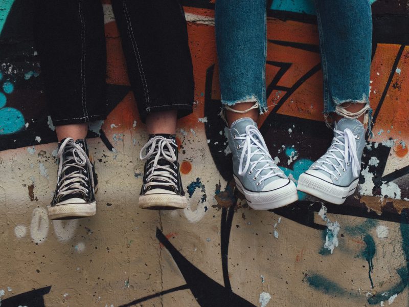close up of colorful converse shoes against graffiti backdrop