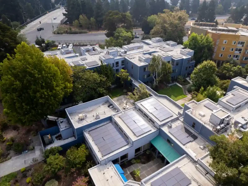 aerial view of a housing complex with solar rooftop panels