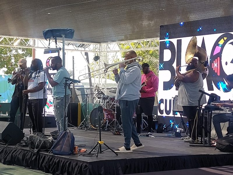 Image of a band playing on a stage.
