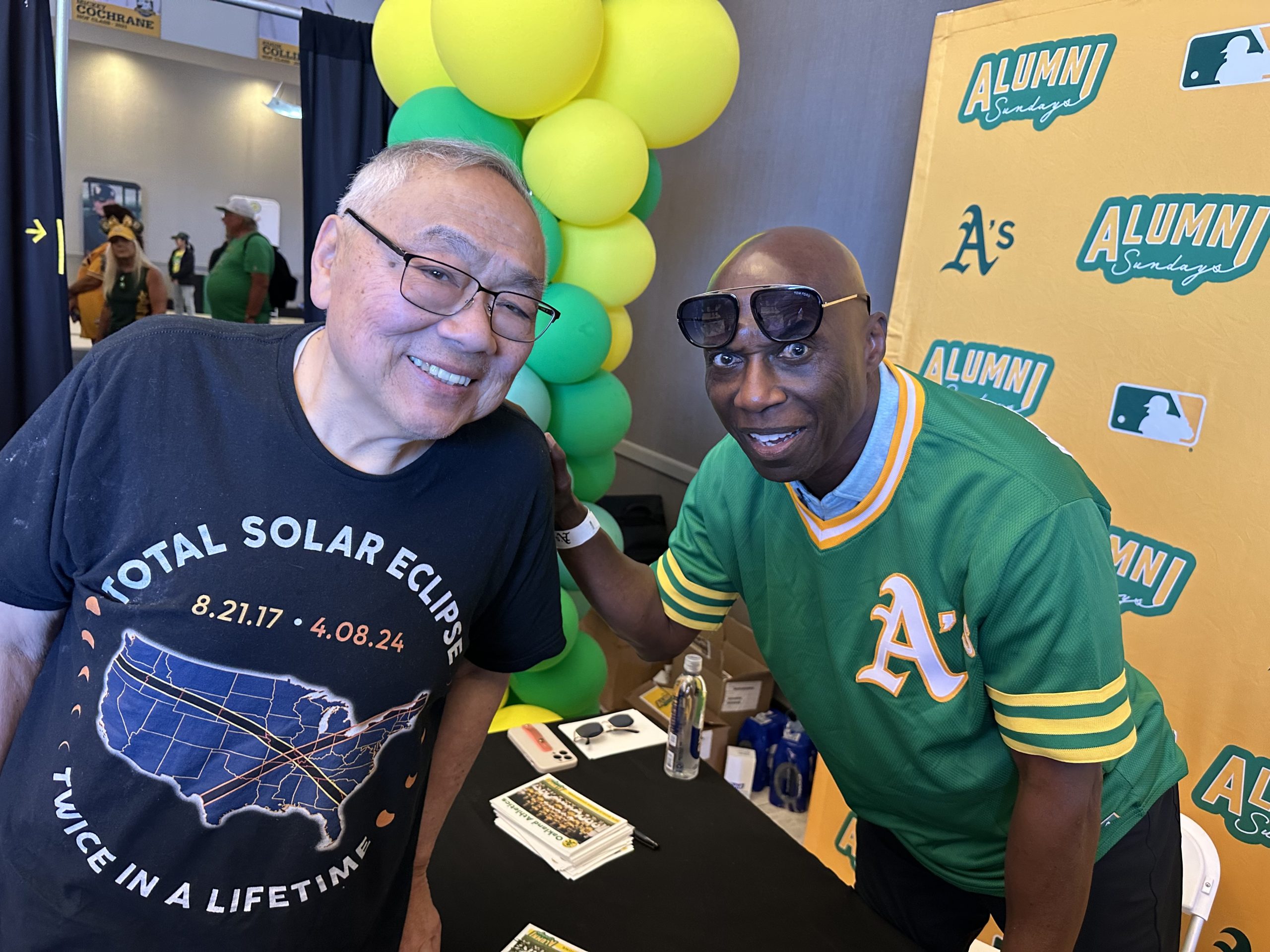 Robert Chan stands next to former player Herb Washington