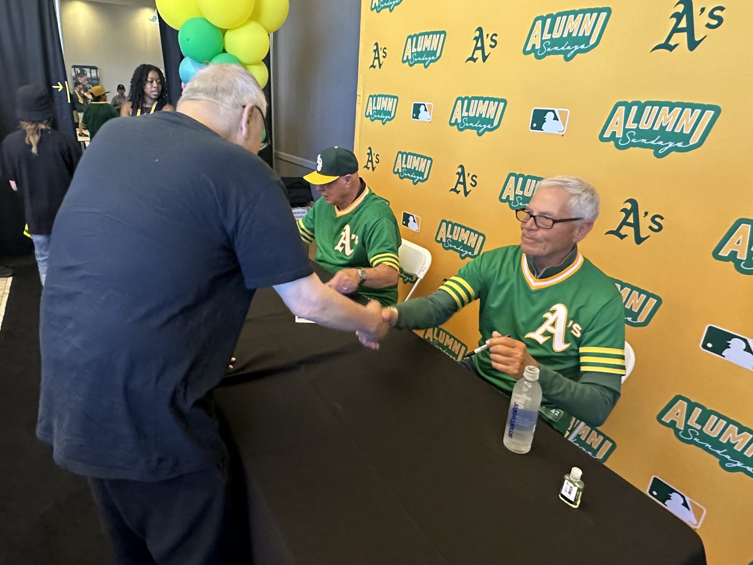 Robert Chan greets former player Dick Green.