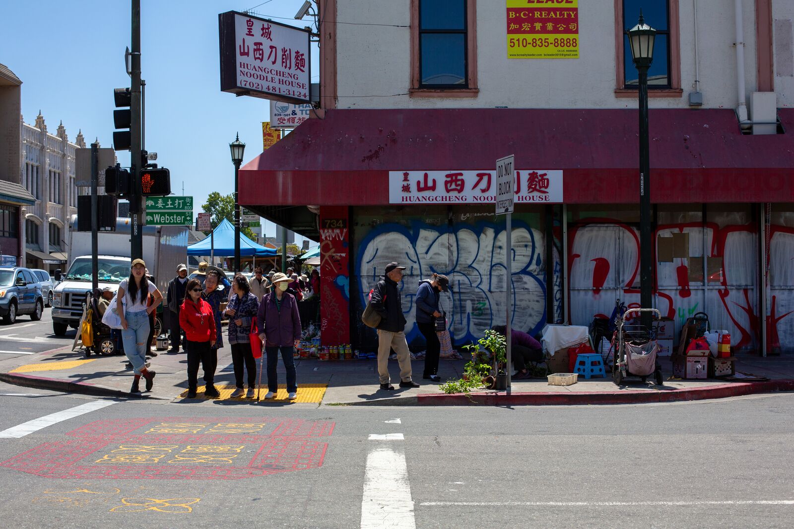 Community members wait at a crosswalk in Oakland Chinatown on June 9, 2024. Credit: Amaya Edwards