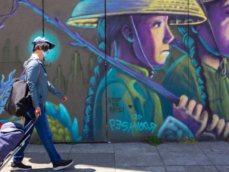 A person walks past a mural painted by Pancho Pescador in Oakland Chinatown on June 9, 2024. Credit: Amaya Edwards Posted in