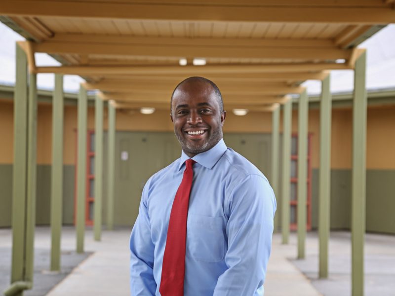 picture of smiling Black man wearing a shirt and tie