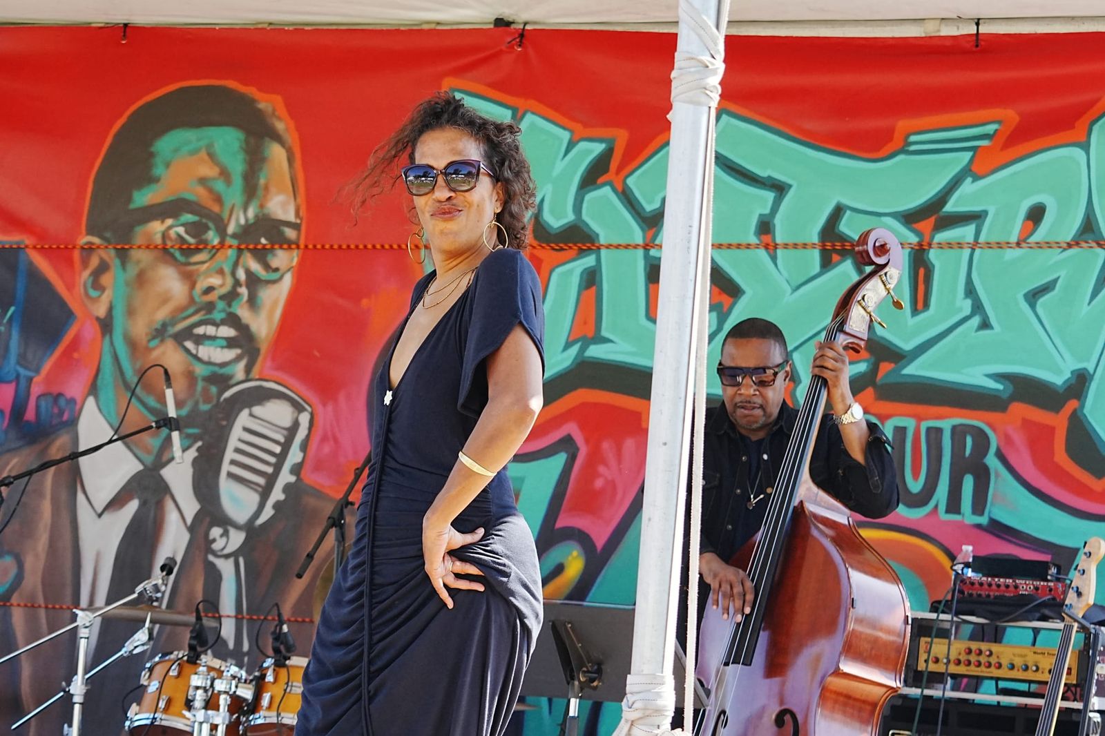 Daria Nile performs on stage while a musician plays upright bass during the Malcolm X JazzArts Festival in Oakland.
